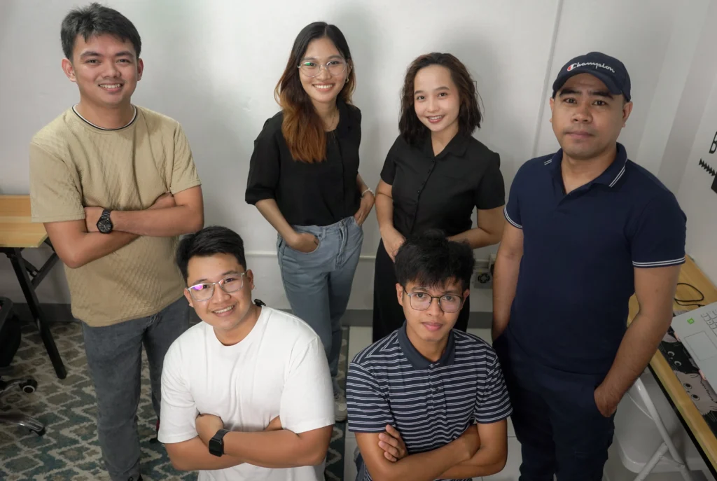 Team members posing together for a group photo after completing a collaborative project.